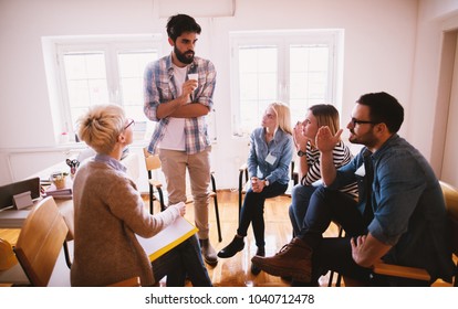 Young People With Problems Listening To Their Nervous Friend Confession While Sitting Together On Special Group Therapy.