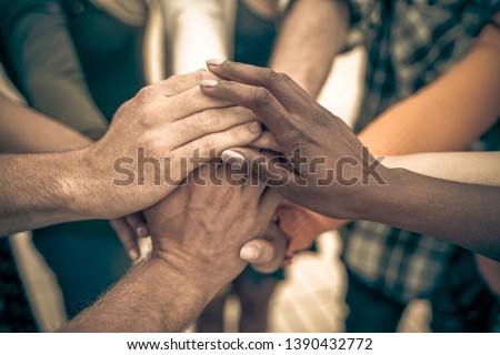 Young people putting their hands together. Friends with stack of hands showing unity and teamwork – Image