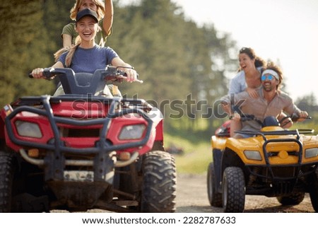 Young people ride quads on a road in the nature. Extreme  sport