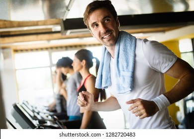 Young People Running On A Treadmill In Health Club.