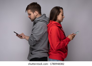 Young people sending messages with mobile phone