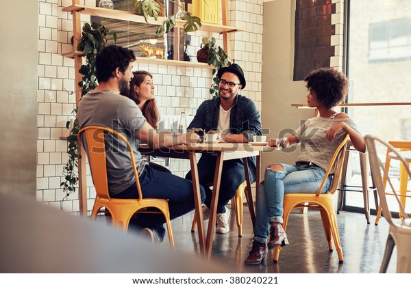 Orang Orang Muda Duduk Di Meja Kafe Foto Stok 380240221 Shutterstock 
