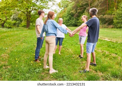 Young People Stand In A Circle And Hold Hands For Team Building And Team Spirit