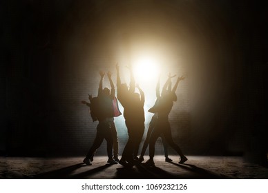 young people standing around with raised hands. praying together to the sun.influence of sect. worship light. worship the Sun. Sun cult. dancing movies - Powered by Shutterstock