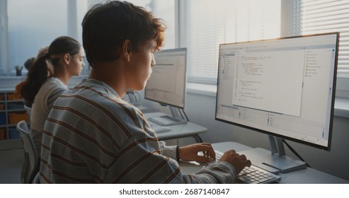 Young People Study Programming in Bright University Classroom. Students Type Computer Code on Monitors, Practicing Teamwork, Software Development, and Essential Digital Skills For Future. Static Shot.