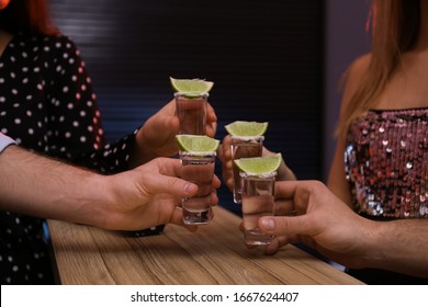 Young people toasting with Mexican Tequila shots at bar, closeup - Powered by Shutterstock