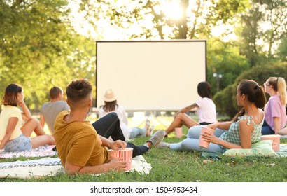 Young People Watching Movie In Open Air Cinema. Space For Text