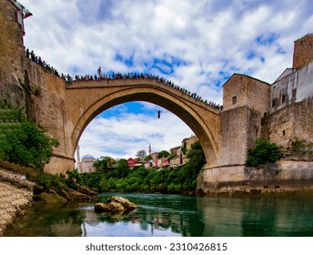 


Young people who used to jump over the Mostar Bridge in Bosnia and Herzegovina to show their courage are now jumping into the cold waters of the Neretva river for a show. We also take pictures. - Shutterstock ID 2310426815