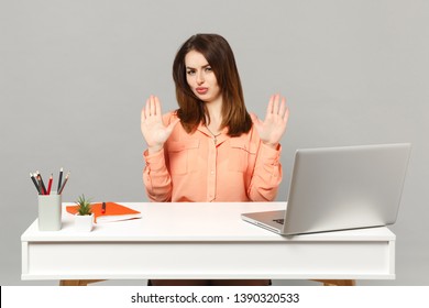 Young Perplexed Woman In Pastel Casual Clothes Showing Palms Saying No Work At White Desk With Pc Laptop Isolated On Gray Background. Achievement Business Career Lifestyle Concept. Mock Up Copy Space