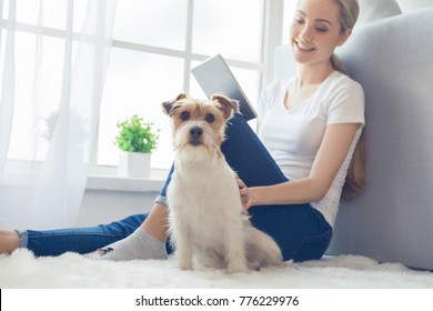 Young person with dog at home leisure