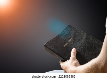 Young Person Holding Bible Book