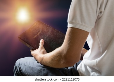 Young Person Holding Bible Book