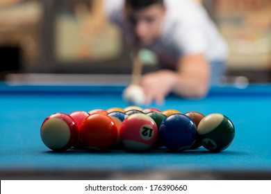 Young Person Playing Snooker - Man Lining To Hit Ball On Pool Table