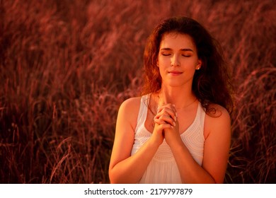Young person praying and silhouette jesus christ cross against sky. spirituality, religion, worshipper, meditation, christianity and national day of prayer. - Shutterstock ID 2179797879