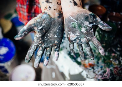 Young Person Showing Hands Covered With Paint During Mass Art Therapy Session