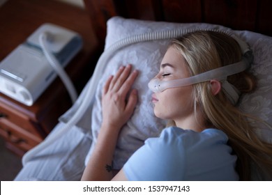 Young person, sleeping with cpap machine. 