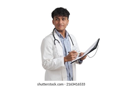 Young Peruvian Male Doctor Writing A Medical Report On A Folder. Isolated Over White Background.