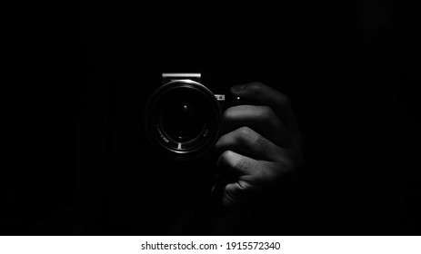 Young Photographer In Black Background