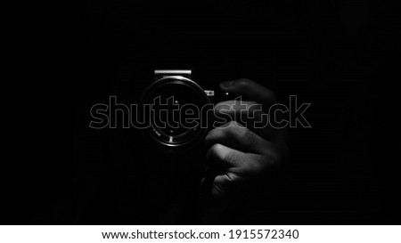 young photographer in black background