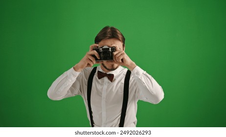 Young Photographer Directing Photoshoot on Green Screen - Powered by Shutterstock