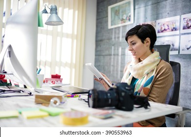 Young Photographer And Graphic Designer At Work In Office