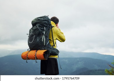 Young photographer makes photos. Majestic Carpathian Mountains. Beautiful landscape of untouched nature.
