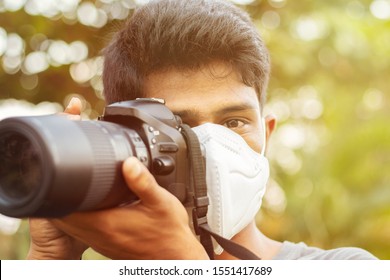 Young Photographer With Pollution Mask - Concept Of Photojournalism And Its Risk.