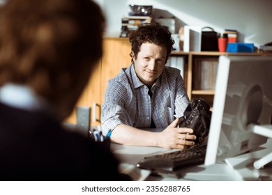 Young photographer showing his work to a colleague - Powered by Shutterstock