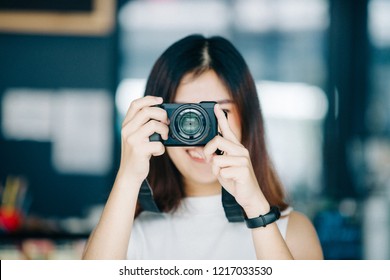 Young photographer taking photos, female photographer lifestyle blogger. - Powered by Shutterstock