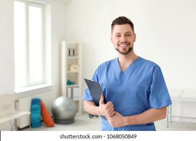 Young Physiotherapist With Clipboard In Rehabilitation Center