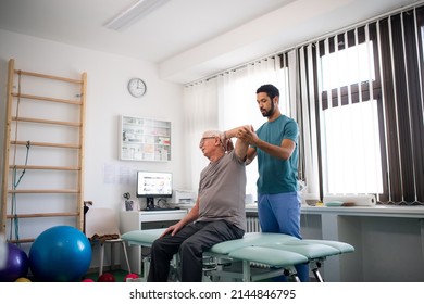 Young physiotherapist exercising with senior patient in a physic room - Powered by Shutterstock