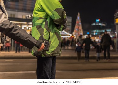 Young Pickpocket Are Stealing Mobile Phone From Jacket Pockets In Public. Concept: Security