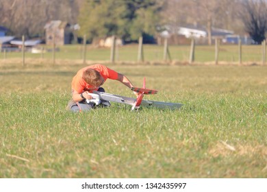 A young pilot checks his instrumentation and plane during Spring break before sending it airborne.  - Powered by Shutterstock