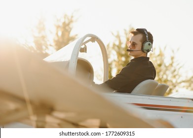 Young pilot is preparing for take off with private plane.