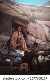 Young Pilot Is Woking Hard. It's Hot Summer Outside. He Is Relaxing On His Aircraft.