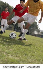 Young Player Playing Soccer On Field