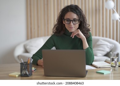 Young Pleasant Italian Woman Freelancer Working On Laptop Computer Remotely From Home, Attractive Spanish Female In Spectacles Studying Online Or Doing Shopping In Internet Store. Freelance Concept