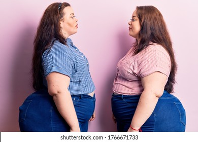 Young Plus Size Twins Wearing Casual Clothes Looking To Side, Relax Profile Pose With Natural Face And Confident Smile. 