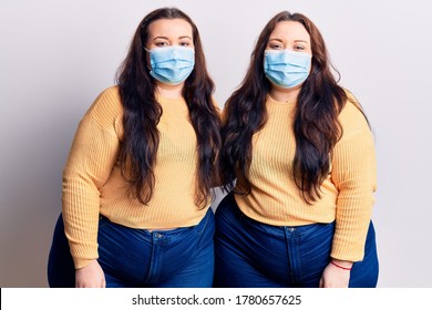 Young Plus Size Twins Wearing Medical Mask With A Happy And Cool Smile On Face. Lucky Person. 