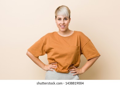 Young Plus Size Woman With Short Hair Confident Keeping Hands On Hips.