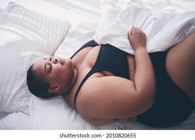 Young, Plus Size Woman Sleeping Peacefully In Bed In The Morning