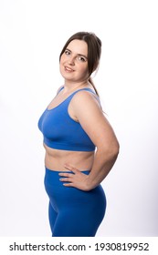 A Young Plus Size Woman In A Sports Uniform Prepares For A Home Workout. Warm Up Before Training. White Background.