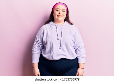 Young plus size woman wearing sportswear with a happy and cool smile on face. lucky person. 