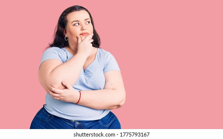 Young plus size woman wearing casual clothes with hand on chin thinking about question, pensive expression. smiling with thoughtful face. doubt concept. 