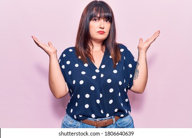 Young Plus Size Woman Wearing Casual Clothes Clueless And Confused With Open Arms, No Idea And Doubtful Face. 