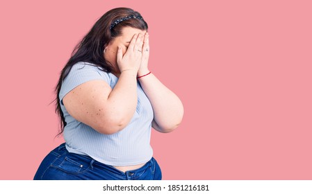 Young Plus Size Woman Wearing Casual Clothes With Sad Expression Covering Face With Hands While Crying. Depression Concept. 