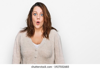 Young plus size woman wearing casual clothes afraid and shocked with surprise expression, fear and excited face. 