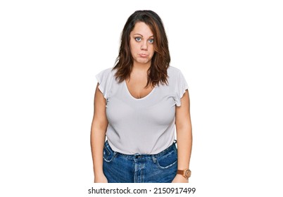 Young Plus Size Woman Wearing Casual White T Shirt Depressed And Worry For Distress, Crying Angry And Afraid. Sad Expression. 