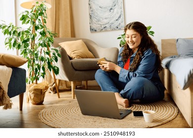 A young plus-size woman smiles while sitting on a cozy rug, engaging with her laptop in a bright, welcoming living space. - Powered by Shutterstock