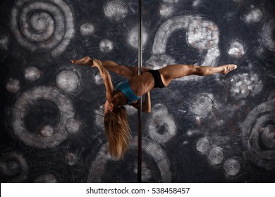 Young pole dance woman. Sexy woman dance in a studio. Pole Fitness for All. Sport concept
